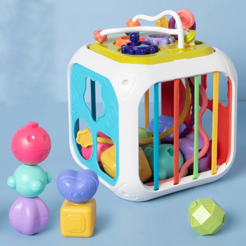 Jouet Montessori bébé 7-en-1 – Boîte sensorielle à formes avec cordes élastiques